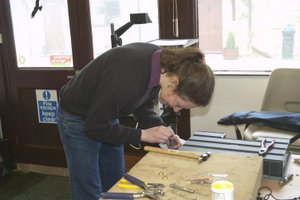 work experience student making falconry equipment